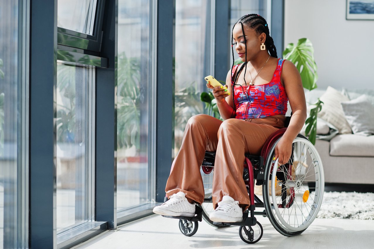 Woman Texting on a Wheelchair 